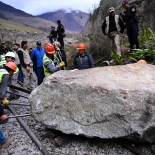 Article thumbnail: Workers attempt to remove a rock placed by rioters on the railway track to block the train's passage to and from the Inca citadel of Machu Picchu in Ollantaytambo, Peru, on December 17, 2022. - Around 5,000 tourists have been left stranded in Cusco, the gateway city to Peru's top attraction Machu Picchu, by deadly protests against the ousting of president Pedro Castillo, a local mayor said on Friday. Rail service to Machu Picchu has been suspended since Tuesday. (Photo by MARTIN BERNETTI / AFP) (Photo by MARTIN BERNETTI/AFP via Getty Images)