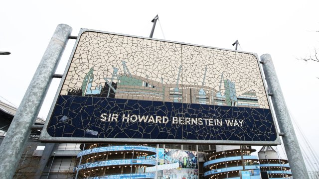 Article thumbnail: MANCHESTER, ENGLAND - DECEMBER 11: A detailed view of the "Sir Howard Bernstein Way" sign outside the stadium prior to the Premier League match between Manchester City and Wolverhampton Wanderers at Etihad Stadium on December 11, 2021 in Manchester, England. (Photo by Jack Thomas - WWFC/Wolves via Getty Images)