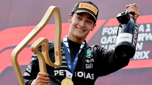 Article thumbnail: Formula One F1 - Austrian Grand Prix - Red Bull Ring, Spielberg, Austria - June 30, 2024 Mercedes' George Russell celebrates with the trophy on the podium after winning the Austrian Grand Prix REUTERS/Leonhard Foeger TPX IMAGES OF THE DAY