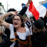 Article thumbnail: People wave French flags as they react to projected results after the second round of the legislative elections, Sunday, July 7, 2024, in Nantes, western France. Polls have closed in France, and polling projections say a coalition on the left that came together unexpectedly has won the most parliamentary seats in the pivotal runoff elections after a high turnout among voters. (AP Photo/Jeremias Gonzalez)