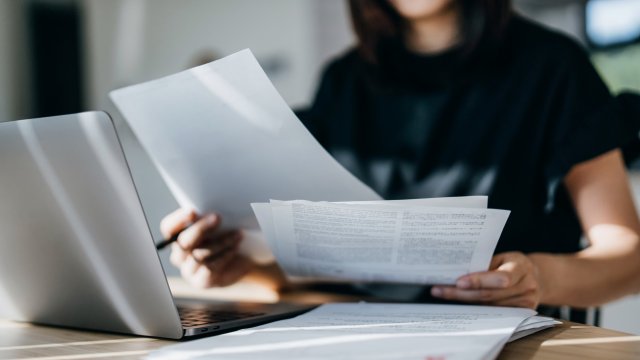 Article thumbnail: Cropped shot of young Asian woman handling personal banking and finance with laptop at home. Planning budget and calculating expenses. Managing taxes and financial bills. Wealth management. Digital banking habits. Smart banking with technology