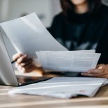 Article thumbnail: Cropped shot of young Asian woman handling personal banking and finance with laptop at home. Planning budget and calculating expenses. Managing taxes and financial bills. Wealth management. Digital banking habits. Smart banking with technology