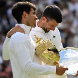 Article thumbnail: Spain's Carlos Alcaraz holding the winner's trophy (L) is congratulated by Serbia's Novak Djokovic during the price ceremony at the end of their men's singles final tennis match on the fourteenth day of the 2024 Wimbledon Championships at The All England Lawn Tennis and Croquet Club in Wimbledon, southwest London, on July 14, 2024. Defending champion Alcaraz beat seven-time winner Novak Djokovic in a blockbuster final, with Alcaraz winning 6-2, 6-2, 7-6. (Photo by ANDREJ ISAKOVIC / AFP) / RESTRICTED TO EDITORIAL USE (Photo by ANDREJ ISAKOVIC/AFP via Getty Images)