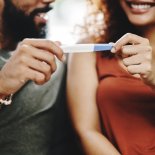 Article thumbnail: Cropped shot of a couple holding a pregnancy test at home