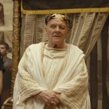 Article thumbnail: THOSE ABOUT TO DIE -- -- Pictured: (l-r) Tom Hughes as Titus, Anthony Hopkins as Emperor Vespasian, Jojo Macari as Domitian (Photo by: PEACOCK)