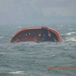 Article thumbnail: In this photo provided by the Philippine Coast Guard, Philippine-flagged motor tanker Terra Nova sinks in Manila Bay, Philippines Thursday, July 25, 2024. The oil tanker sank in Manila Bay early Thursday after encountering huge waves and the coast guard is now assessing the vessel for a leak that could cause a major spill that could reach the capital Manila, Philippine's coast guard said. (Philippine Coast Guard via AP)